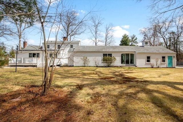 279 Norfolk St, Holliston, MA 01746 - back of property featuring a yard, a wooden deck, and a chimney