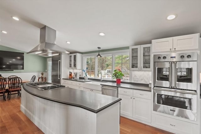 279 Norfolk St, Holliston, MA 01746 - kitchen with stainless steel appliances, island range hood, dark countertops, white cabinets, and recessed lighting