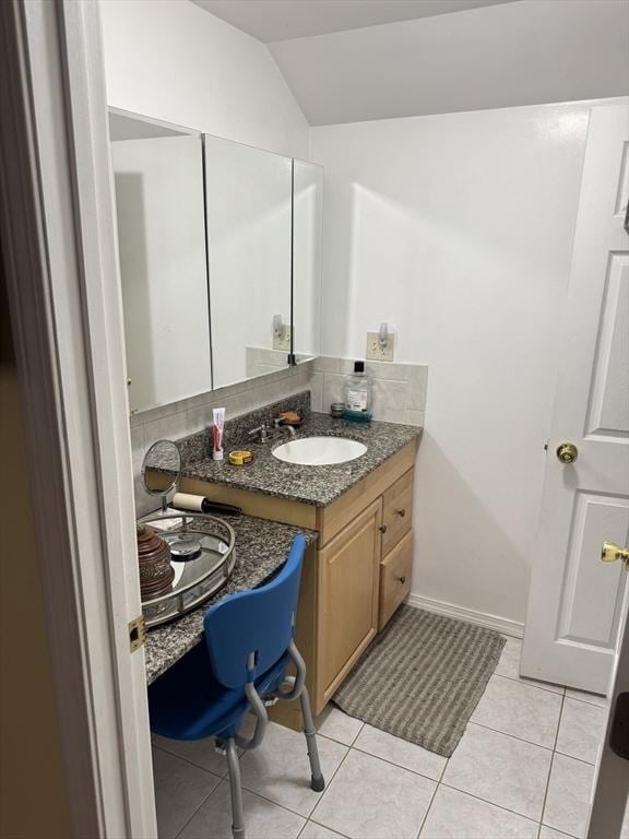 251 Waltham St, Newton, MA 02465 - bathroom featuring vanity, vaulted ceiling, tile patterned floors, and baseboards