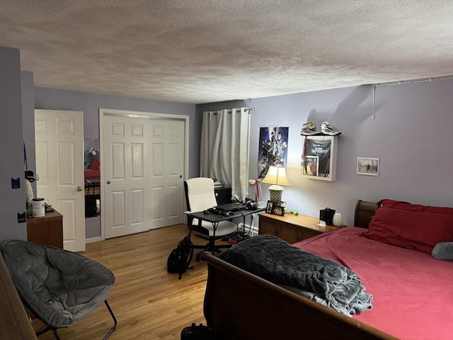 251 Waltham St, Newton, MA 02465 - bedroom featuring a textured ceiling, light wood finished floors, an office area, and a closet