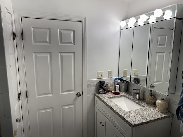 251 Waltham St, Newton, MA 02465 - bathroom featuring vanity and tile walls