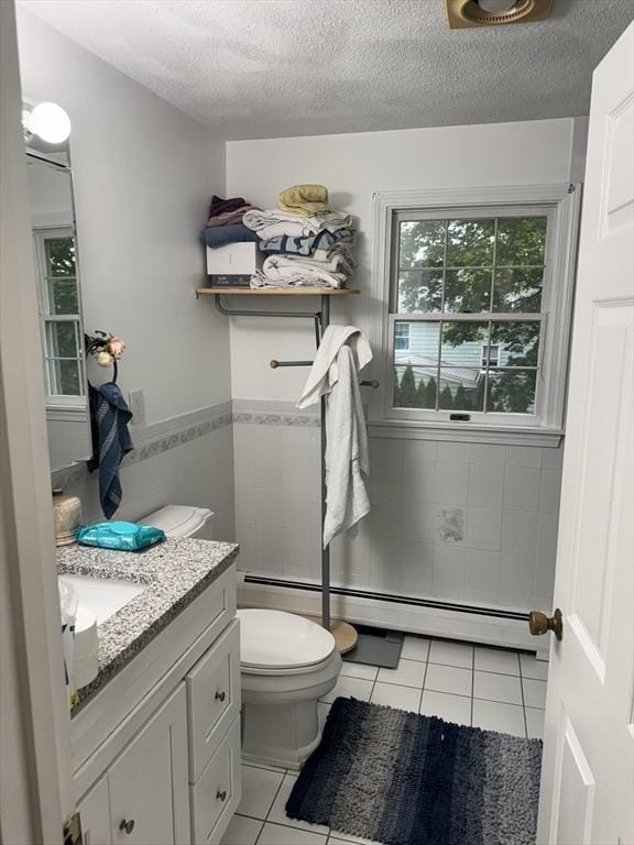 251 Waltham St, Newton, MA 02465 - bathroom featuring tile walls, tile patterned flooring, toilet, baseboard heating, and vanity