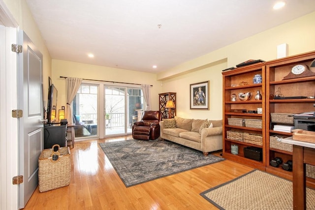 living room with recessed lighting and light wood-style floors