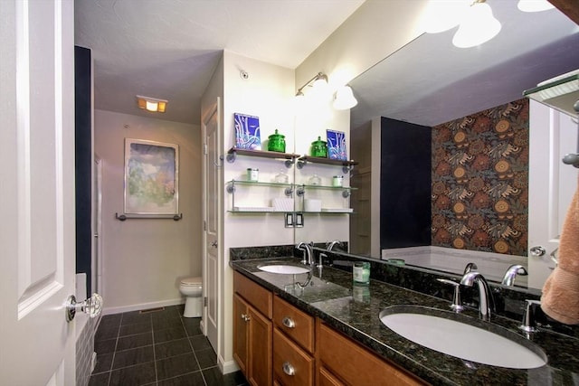 full bathroom featuring double vanity, a sink, toilet, and tile patterned floors