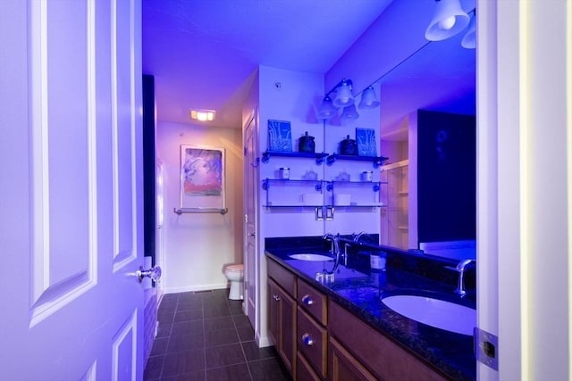 full bath with tile patterned flooring, a sink, toilet, and double vanity