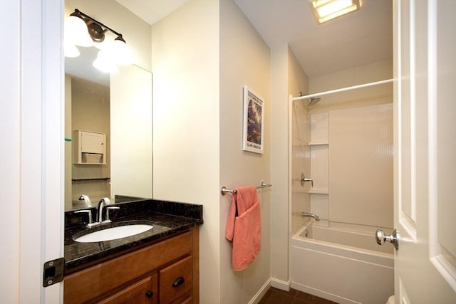 bathroom with shower / washtub combination, vanity, and baseboards