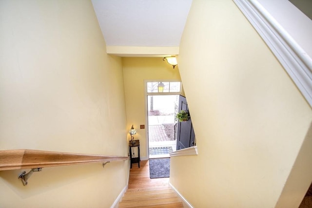 stairway featuring baseboards and wood finished floors