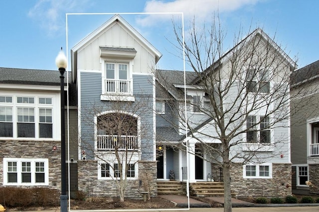 view of front of home with stone siding and board and batten siding