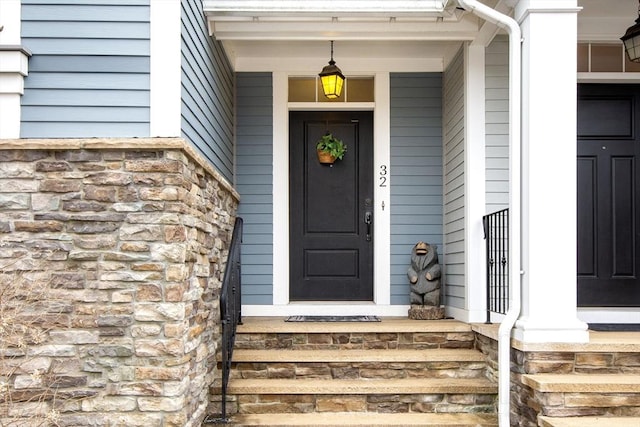 view of exterior entry featuring stone siding