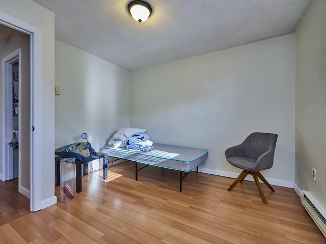 sitting room featuring light hardwood / wood-style flooring and a baseboard radiator