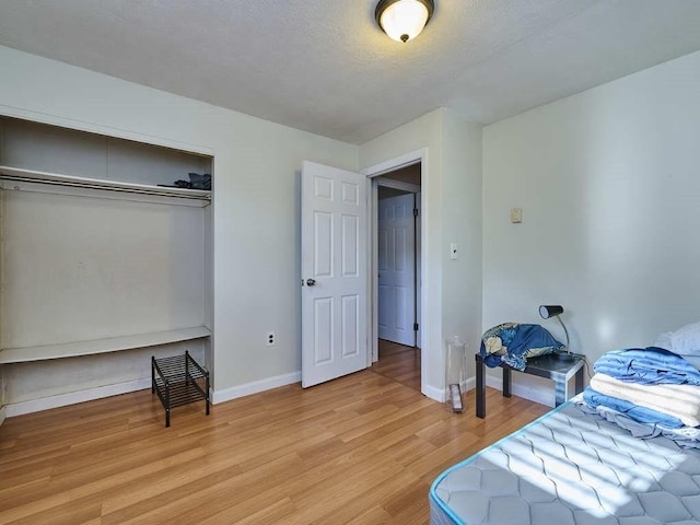 bedroom featuring light hardwood / wood-style flooring and a closet