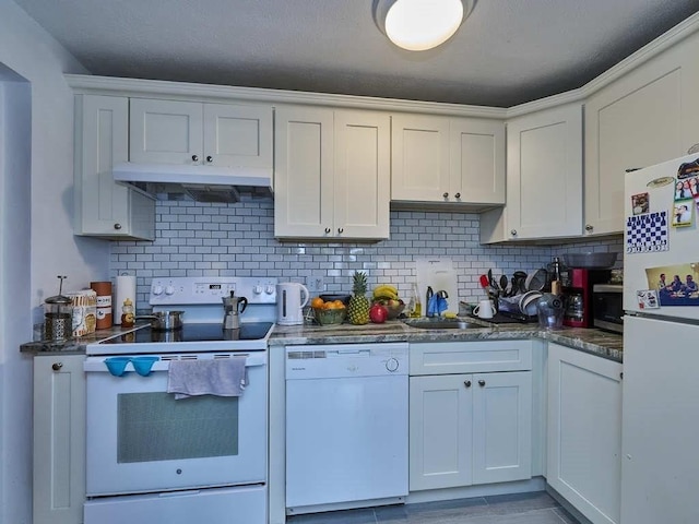 kitchen with white cabinets, white appliances, sink, and backsplash