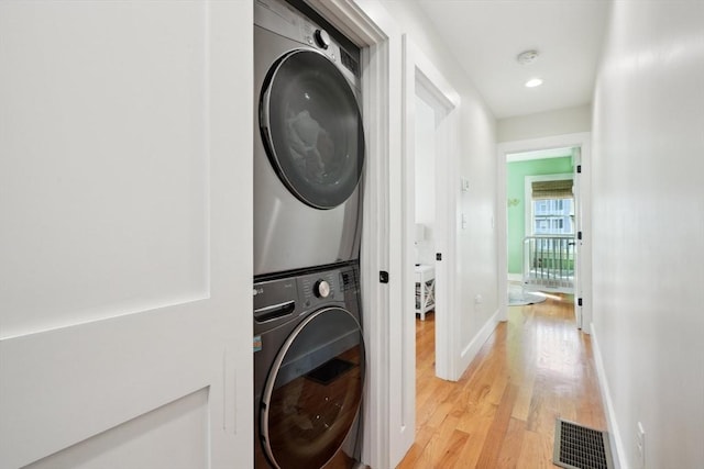 10 Berkley Rd Unit C, Hull, MA 02045 - laundry room with stacked washer and clothes dryer, light wood finished floors, and baseboards