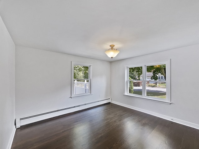 unfurnished room with a baseboard radiator, a healthy amount of sunlight, and dark hardwood / wood-style floors