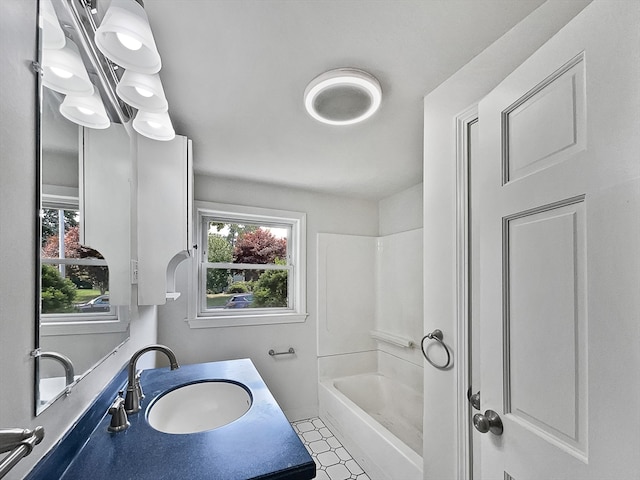 bathroom with vanity, plenty of natural light, and bathing tub / shower combination