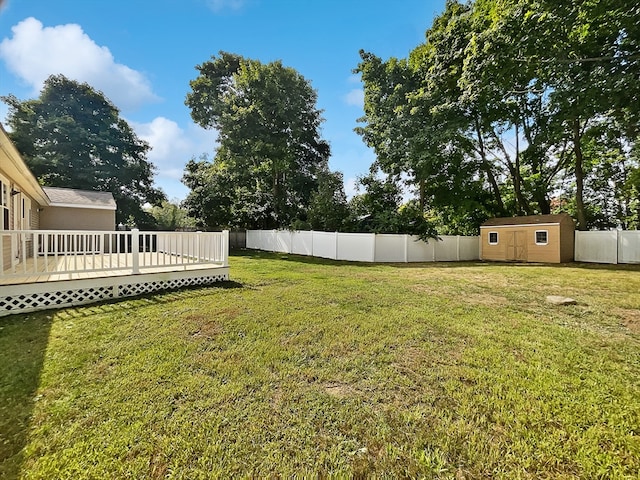 view of yard featuring a deck and a shed