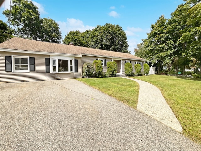 ranch-style home with a front lawn