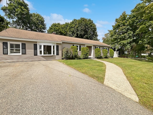 ranch-style home featuring a front yard