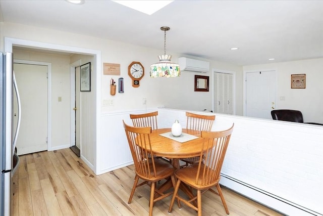 15 Trask Rd, Peabody, MA 01960 - dining space with a wall mounted AC, a baseboard heating unit, light wood-style floors, a wainscoted wall, and recessed lighting