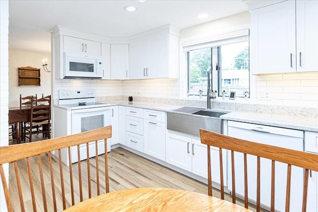 15 Trask Rd, Peabody, MA 01960 - kitchen featuring white appliances, white cabinets, decorative backsplash, light wood-style flooring, and recessed lighting