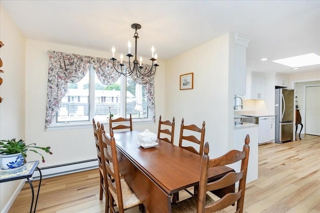 15 Trask Rd, Peabody, MA 01960 - dining room with light wood-style flooring, baseboard heating, a chandelier, a skylight, and recessed lighting