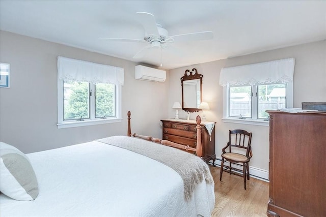 15 Trask Rd, Peabody, MA 01960 - bedroom with a wall unit AC, multiple windows, light wood-style flooring, and baseboard heating