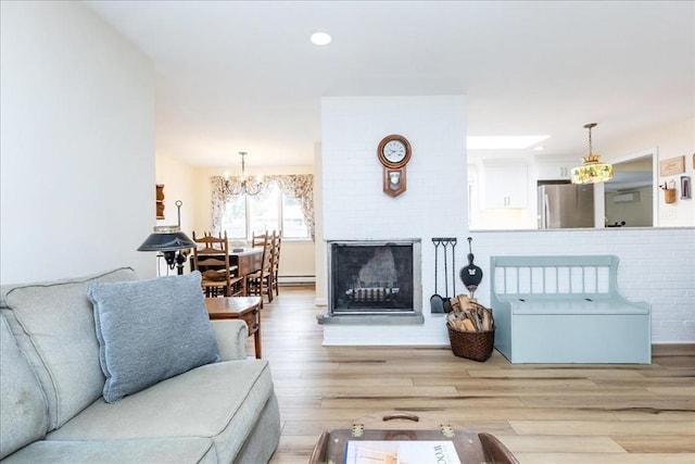 15 Trask Rd, Peabody, MA 01960 - living area featuring a chandelier, a baseboard heating unit, wood finished floors, and recessed lighting