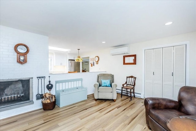 15 Trask Rd, Peabody, MA 01960 - sitting room featuring a wall unit AC, a baseboard heating unit, light wood-type flooring, a brick fireplace, and recessed lighting