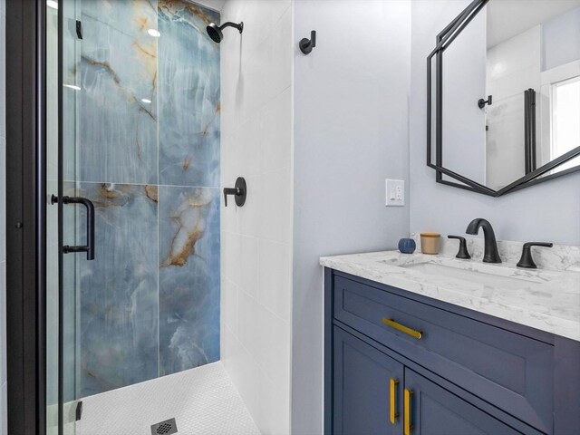 bathroom featuring vanity and a shower with door