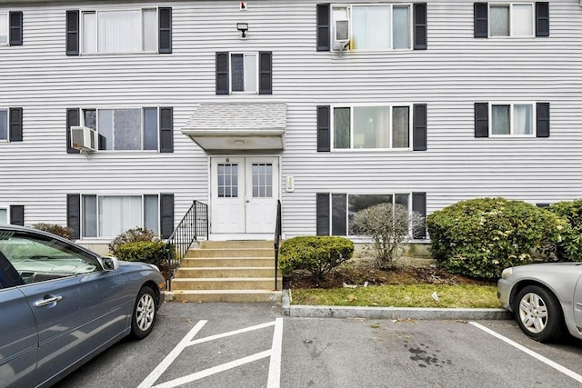 view of property featuring uncovered parking