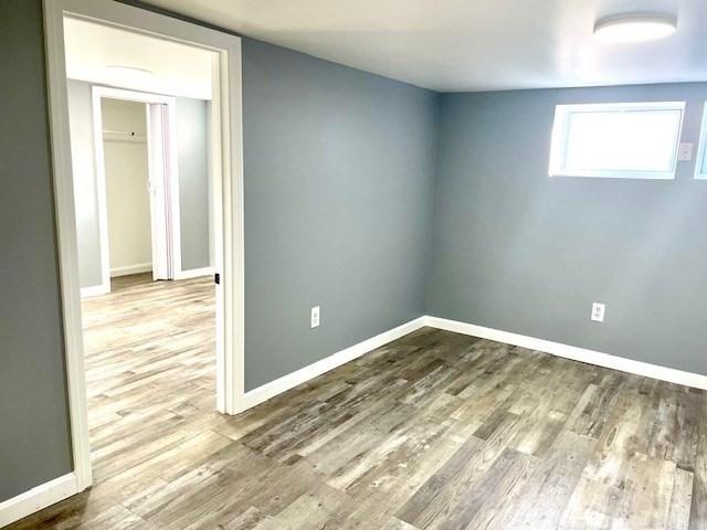 unfurnished room featuring hardwood / wood-style floors