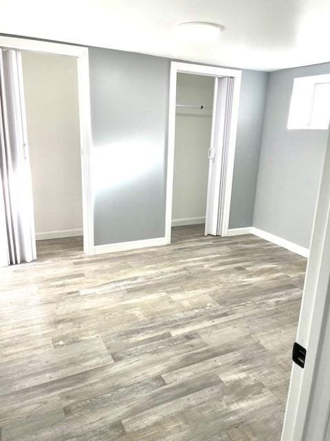 unfurnished bedroom with wood-type flooring