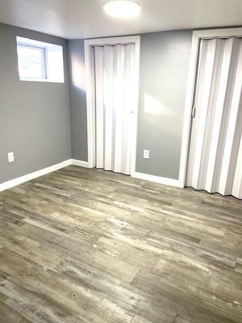 unfurnished bedroom with wood-type flooring