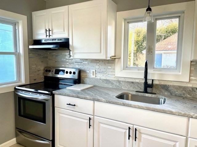 kitchen featuring extractor fan, white cabinetry, sink, pendant lighting, and stainless steel electric stove