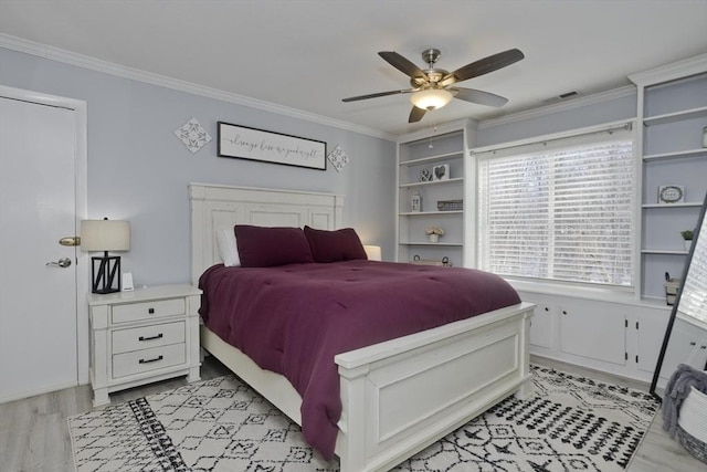 bedroom featuring ornamental molding, light wood-type flooring, visible vents, and ceiling fan