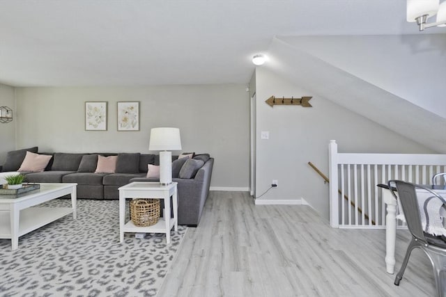 living area featuring light wood-style floors and baseboards