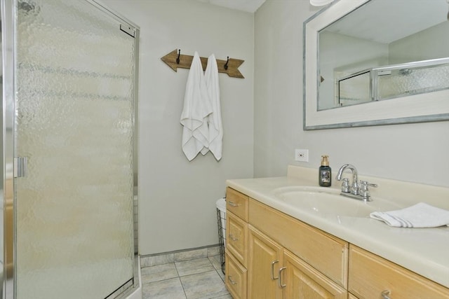 bathroom featuring a stall shower, vanity, and tile patterned floors