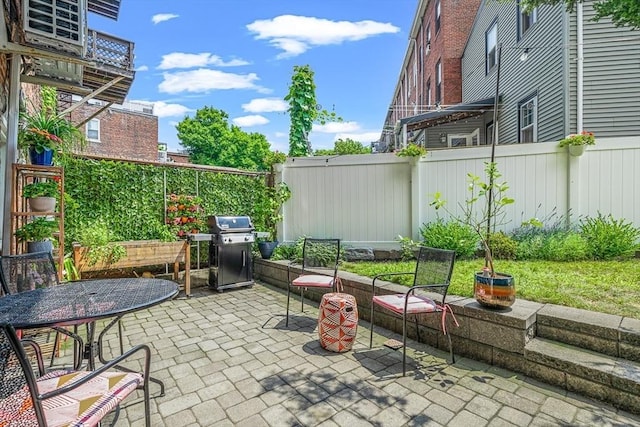 view of patio / terrace with grilling area and a fenced backyard