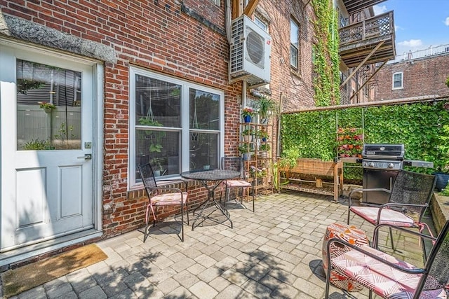 view of patio / terrace with area for grilling and ac unit