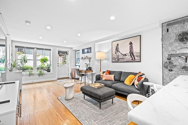 living room featuring recessed lighting, baseboards, and wood finished floors