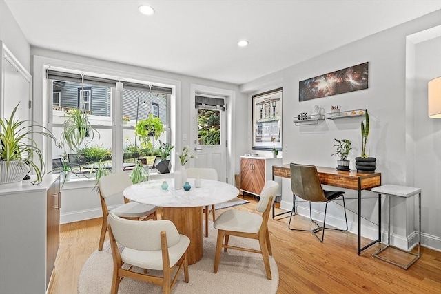 dining room featuring recessed lighting, baseboards, and light wood finished floors