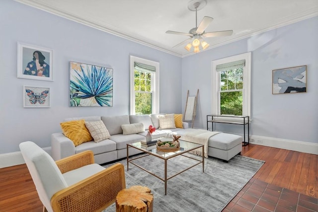 living area featuring ornamental molding, plenty of natural light, baseboards, and wood finished floors