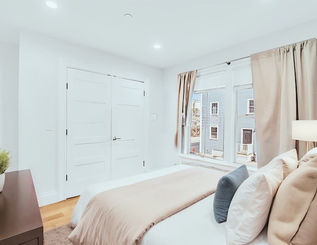 bedroom featuring a closet and light wood-type flooring