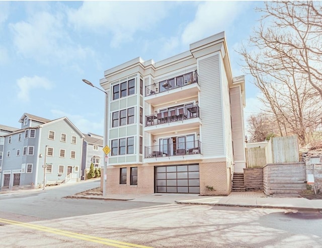 56 Belmont St Unit 3, Boston, MA 02129 - view of apartment building / complex featuring concrete driveway and an attached garage