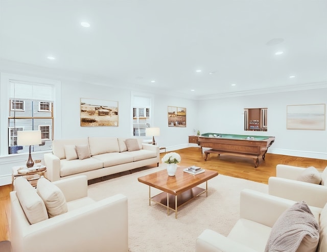 living room with crown molding, pool table, and light wood-type flooring