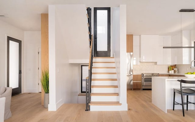 stairs with hardwood / wood-style floors