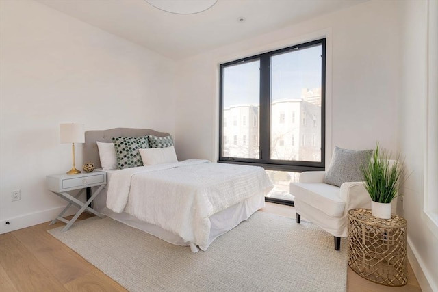 bedroom featuring wood-type flooring and multiple windows