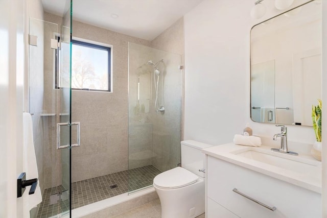 bathroom featuring tile patterned floors, vanity, toilet, and an enclosed shower