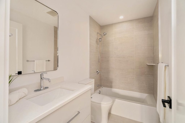 full bathroom featuring toilet, vanity, and tiled shower / bath