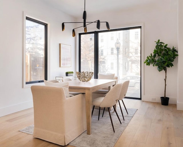 dining room featuring a chandelier and light wood-type flooring